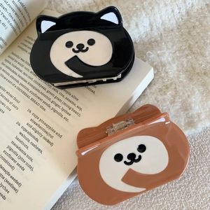 Cute acetate dog-shaped hair claws in black and brown displayed on white fleece background