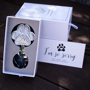 Crystal pet memorial suncatcher with paw print charm in a gift box with a sympathy card
