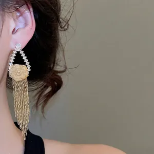 Elegant gold plated flower tassel earrings with zircons shown on model for women