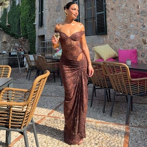Detail of dark brown lace maxi dress featuring waist cut-outs and shoulder rings