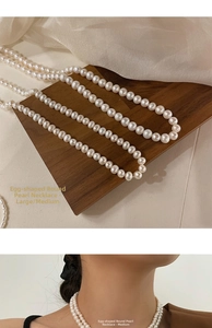 Macro detail of natural freshwater oval pearls in medium and large sizes on wood