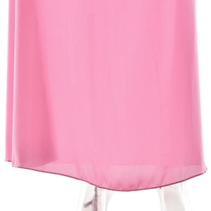Detail shot of the pleated hem on a pink chiffon dress with elegant draping effect