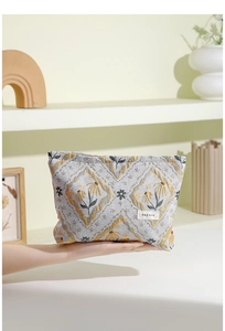 Close-up of vintage floral jacquard fabric texture and brand label on a makeup bag
