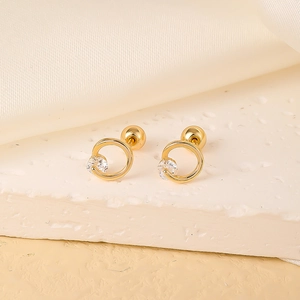 Detail of gold circular stud earring with white zircon and secure ball screw back