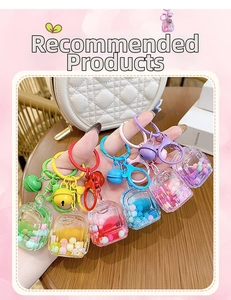 Close-up of colorful liquid sand backpack keychains with bells and spring clips