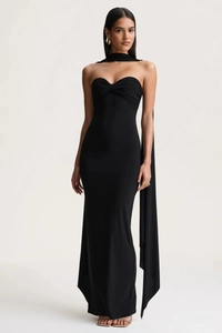 Detail of twisted knot bodice and long scarf on elegant black halter maxi dress