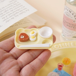 Miniature bear-shaped dollhouse plate set with realistic food props held in hand