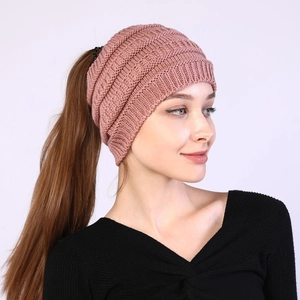 Detail of pink knitted headband showing thick yarn texture and ponytail opening