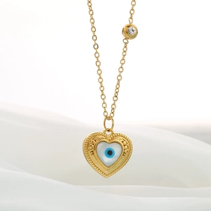 Macro shot of 18k gold plated heart necklace with blue evil eye and sparkling crystal detail