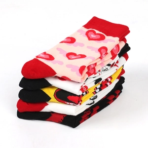 Close-up of neatly stacked cotton crew socks with various heart and colorful patterns