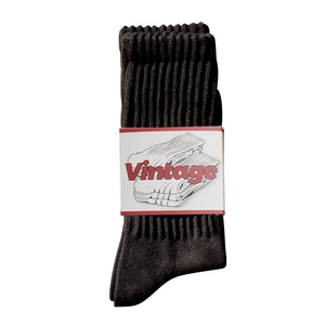 Chaussettes vintage en coton noir avec bande papier sur fond blanc professionnel