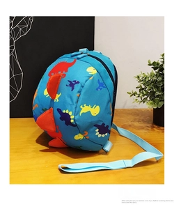 Detail of blue cartoon dinosaur backpack with 3D orange fins and colorful prints