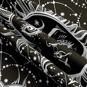 Close-up of bohemian sun and stars print showing detailed black fabric texture