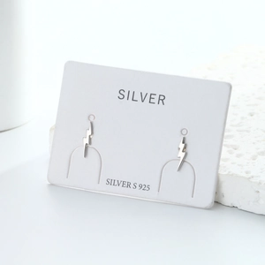 Detailed view of minimalist S925 sterling silver lightning bolt studs on display