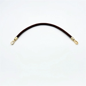 Detail of dark brown PU leather shoulder strap with golden metal lobster hooks
