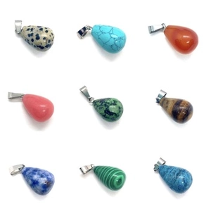Macro view of nine teardrop natural stone pendants with silver metal bails