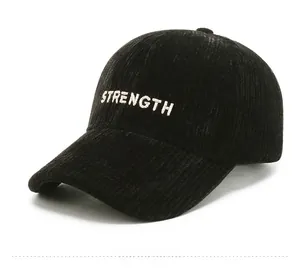 Detailed side view of black corduroy baseball cap with white STRENGTH embroidery
