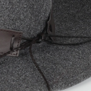 Macro shot of dark grey wool felt fedora with premium brown leather band and cord detail