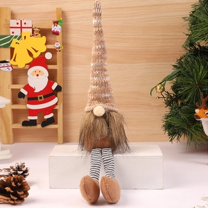 Christmas gnome doll with brown knit hat and striped long legs on white wood block