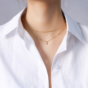 Double layered 18K gold plated titanium steel necklace featuring a single zircon pendant