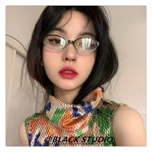 Close-up of vintage oval light green glasses frames on a female model face