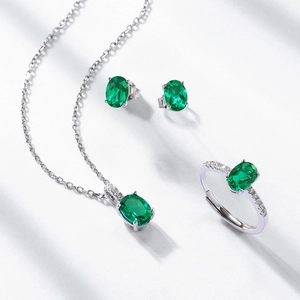 Elegant S925 silver jewelry set with oval emerald gemstones: necklace, ring, and earrings