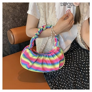 Detailed view of rainbow gradient pleated cloud bag with soft texture and vibrant colors