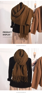 Detail showing the thick texture and colorful polka dots of this brown scarf with tassels