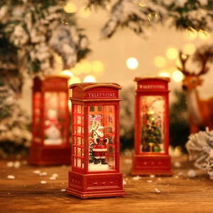 Close-up of a festive red Christmas telephone booth lamp with Santa and snow scene