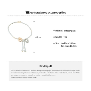 Detailed view of imitation pearl choker necklace with bow pendant and exact dimensions