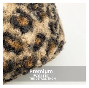 Close-up of leopard print faux fur texture with dense fibers in brown and beige