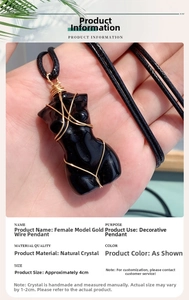 Detailed view of female torso crystal pendant with gold wire wrapping and size scale