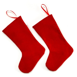 Detailed view of two festive red felt Christmas stockings with hanging loops on white background