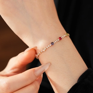 Detail of vintage gold bracelet with vibrant round-cut colorful zircons and micro-pave stones
