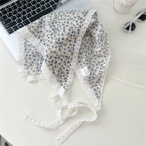 Detailed view of floral cotton neckerchief with white crochet lace edging and blue prints