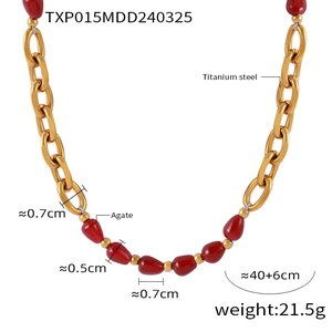 Macro shot of gold plated titanium steel necklace with red pomegranate agate beads detail