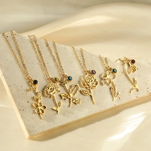 Detail of 18k gold plated stainless steel hollow flower pendants with colorful birthstones