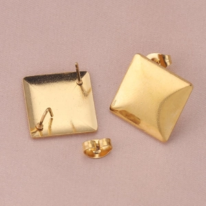 Polished gold square stud earrings with butterfly backings on a light pink textured background