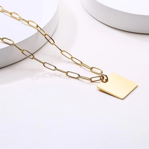 Detail of 18k gold plated paperclip chain necklace with a smooth rectangular pendant