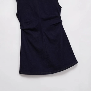 Sleeveless crewneck dark blue denim dress with pleated waist detail in flat lay view