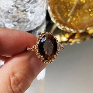 Macro detail of vintage rose gold ring featuring an oval smoky quartz stone