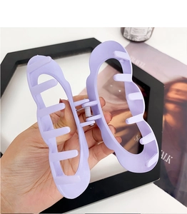 Detail of a large matte purple butterfly hair claw clip for thick hair styling