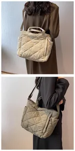 Detail of quilted tote bag in beige and olive with rhombic texture and adjustable strap
