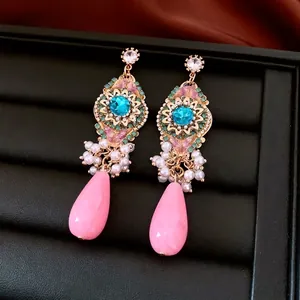 Vintage gold drop earrings with blue gemstone, floral accents and white pearls