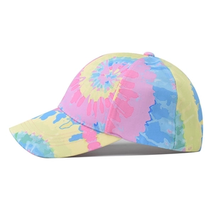 Gradient tie-dye baseball cap with vibrant swirl patterns and curved brim in side view