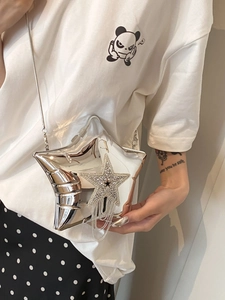 Detailed view of silver star shoulder bag with rhinestone fringe on a female model