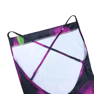 Detail of cross-back straps with metal adjustment buckles on floral print dress