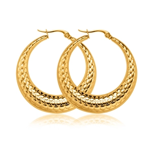 Macro detail of gold-plated C-shaped earrings with unique honeycomb textured surface