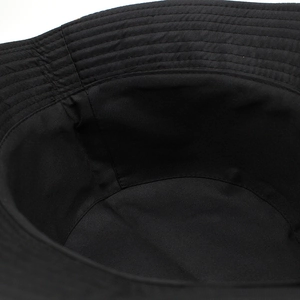 Gros plan des coutures internes et de la texture en coton d'un chapeau bob noir