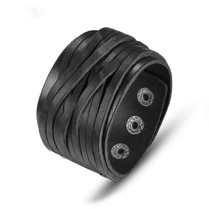 Close-up of black braided leather multi-layer wide bracelet with adjustable metal snap button